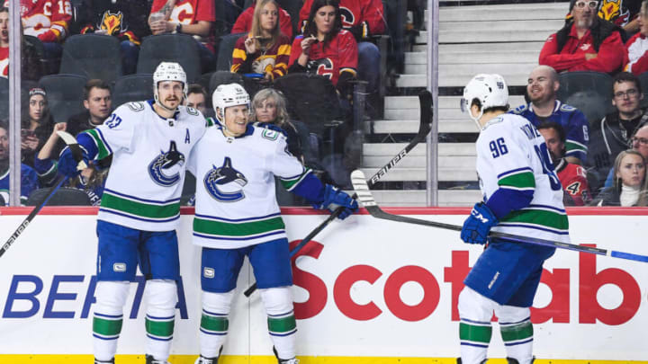 CALGARY, CANADA - DECEMBER 14: Sheldon Dries #15 (C) of the Vancouver Canucks celebrates after scoring against the Calgary Flames during the second period of an NHL game at Scotiabank Saddledome on December 14, 2022 in Calgary, Alberta, Canada. (Photo by Derek Leung/Getty Images)