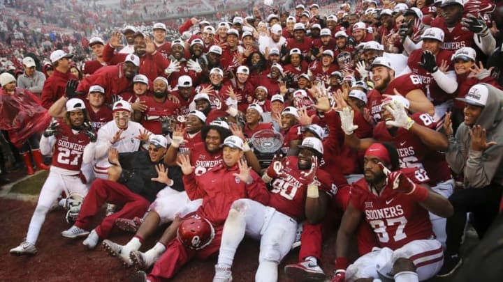 Dec 3, 2016; Norman, OK, USA; Oklahoma Sooners coaches and players take a team photo with the Big 12 championship trophy after the game against the Oklahoma State Cowboys at Gaylord Family – Oklahoma Memorial Stadium. Mandatory Credit: Kevin Jairaj-USA TODAY Sports