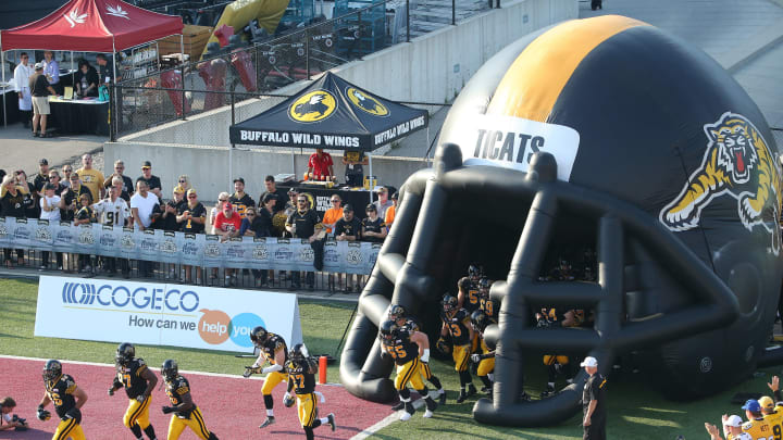 HAMILTON, CANADA – JULY 26: Hamilton Tiger-Cats players run out onto the field before the start of CFL game action against the Ottawa Redblacks on July 26, 2014 at Ron Joyce Stadium in Hamilton, Ontario, Canada. (Photo by Tom Szczerbowski/Getty Images)