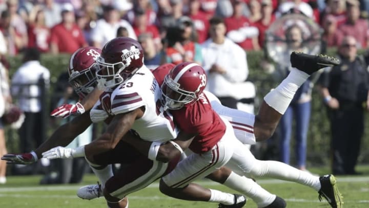 Nov 12, 2016; Tuscaloosa, AL, USA; Alabama Crimson Tide defensive back Levi Wallace (39) and linebacker Anfernee Jennings (33) wrap up Mississippi State Bulldogs wide receiver Keith Mixon (23) on a punt return at Bryant-Denny Stadium. The Tide defeated the Bulldogs 51-3. Mandatory Credit: Marvin Gentry-USA TODAY Sports