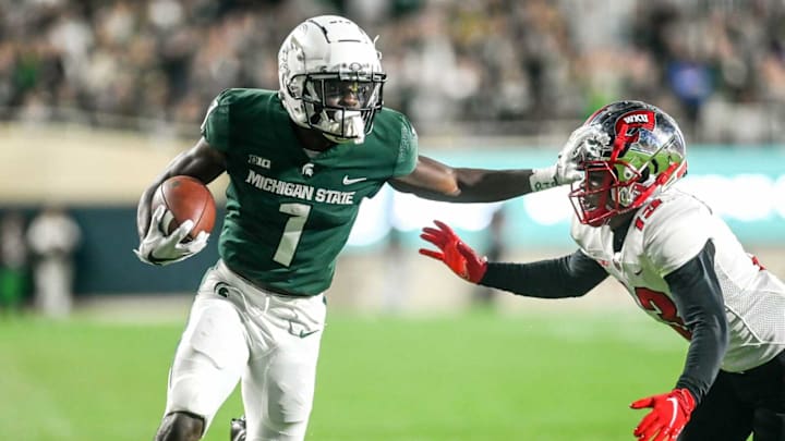 Michigan State’s Jayden Reed, left, stiff arms Western Kentucky’s Miguel Edwards on his way to the end zone on a catch during the first quarter on Saturday, Oct. 2, 2021, at Spartan Stadium in East Lansing.211002 Msu Wku Fb 115a