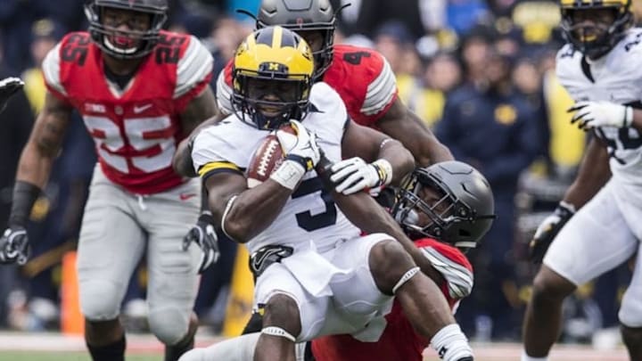 Nov 26, 2016; Columbus, OH, USA; Michigan Wolverines linebacker Jabrill Peppers (5) is tackled by Ohio State Buckeyes wide receiver Terry McLaurin (83) after an interception at Ohio Stadium. Ohio State won the game 30-27 in double overtime. Mandatory Credit: Greg Bartram-USA TODAY Sports