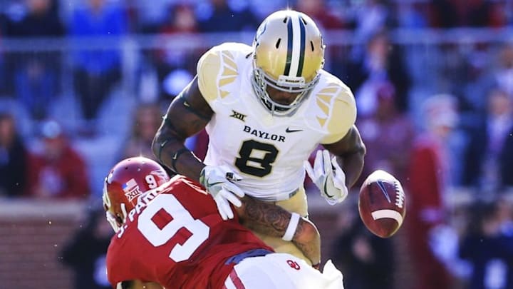 Nov 12, 2016; Norman, OK, USA; Oklahoma Sooners cornerback Jordan Parker (9) hits Baylor Bears wide receiver Ishmael Zamora (8) and causes a fumble during the second quarter at Gaylord Family - Oklahoma Memorial Stadium. Mandatory Credit: Kevin Jairaj-USA TODAY Sports