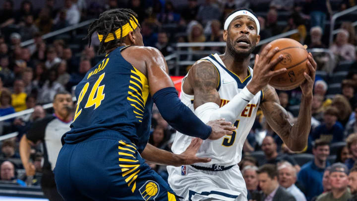 30 Mar. 2022; Indianapolis, Indiana, USA; Denver Nuggets forward Will Barton (5) controls the ball while Indiana Pacers guard Buddy Hield (24) defends in the first half at Gainbridge Fieldhouse. (Trevor Ruszkowski-USA TODAY Sports)