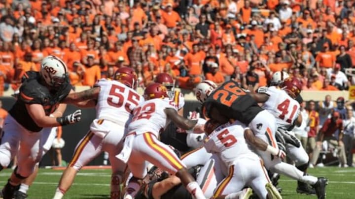 Oct 4, 2014; Stillwater, OK, USA; Oklahoma State Cowboys running back Desmond Roland (26) scores a touchdown during the first half against the Iowa State Cyclones at Boone Pickens Stadium. Mandatory Credit: Denny Medley-USA TODAY Sports Oct 4, 2014; Stillwater, OK, USA; Oklahoma State Cowboys running back Desmond Roland (26) scores a touchdown during the first half against the Iowa State Cyclones at Boone Pickens Stadium. Mandatory Credit: Denny Medley-USA TODAY Sports