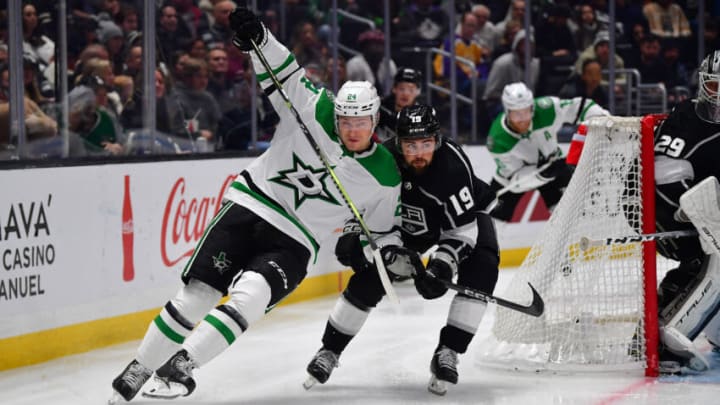 Jan 3, 2023; Los Angeles, California, USA; Los Angeles Kings left wing Alex Iafallo (19) plays for the puck against Dallas Stars center Roope Hintz (24) during the third period at Crypto.com Arena. Mandatory Credit: Gary A. Vasquez-USA TODAY Sports