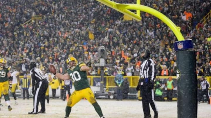 Dec 22, 2013; Green Bay, WI, USA; Green Bay Packers fullback John Kuhn (30) spikes the ball after scoring a touchdown in the 4th quarter against the Pittsburgh Steelers at Lambeau Field. Mandatory Credit: Benny Sieu-USA TODAY Sports