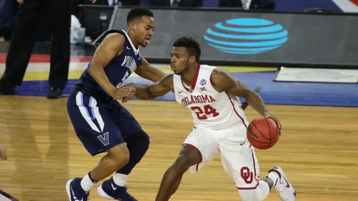 Apr 2, 2016; Houston, TX, USA; Oklahoma Sooners guard Buddy Hield (24) works around the defense of Villanova Wildcats guard Phil Booth (5) during the first half in the 2016 NCAA Men