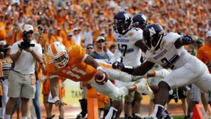 Jan 1, 2016; Tampa, FL, USA; Tennessee Volunteers quarterback Joshua Dobbs (11) runs the ball in for a touchdown against the Northwestern Wildcats during the second half in the 2016 Outback Bowl at Raymond James Stadium. Tennessee Volunteers defeated the Northwestern Wildcats 45-6. Tennessee Volunteers Mandatory Credit: Kim Klement-USA TODAY Sports