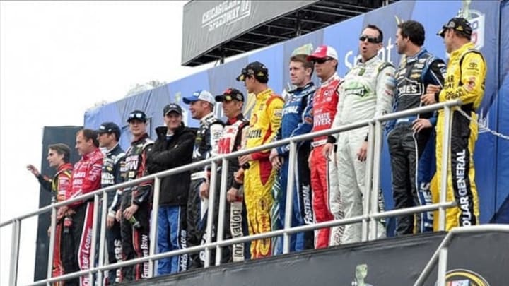 Sep 15, 2013; Joliet, IL, USA; NASCAR Sprint Cup Series drivers in the Chase (from left to right) Jeff Gordon (24), Ryan Newman (39), Kasey Kahne (5), Kurt Busch (78), Dale Earnhardt Jr. (88), Clint Bowyer (15), Greg Biffle (16), Joey Logano (22), Carl Edwards (99), Kevin Harvick (29), Kyle Busch (18), Jimmie Johnson (48), and Matt Kenseth (20) before the Geico 400 at Chicagoland Speedway. Mandatory Credit: Rob Grabowski-USA TODAY Sports