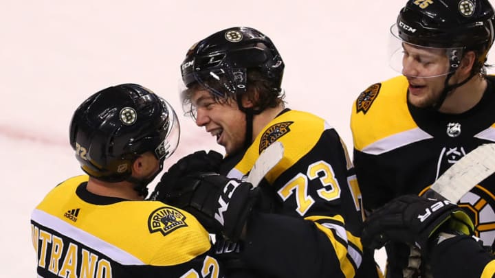 BOSTON - DECEMBER 21: Boston Bruins' Charlie McAvoy is congratulated by teammates Frank Vatrano, left, and Brandon Carlo after McAvoy's game-winning goal in overtime. The Boston Bruins host the Winnipeg Jets in a regular season NHL hockey game at TD Garden in Boston on Dec. 21, 2017. (Photo by John Tlumacki/The Boston Globe via Getty Images)