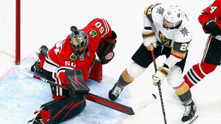 Corey Crawford #50 of the Chicago Blackhawks makes the first period save as William Carrier #28 of the Vegas Golden Knights looks for the rebound in Game Four of the Western Conference First Round