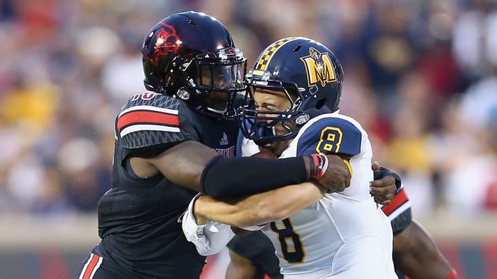 LOUISVILLE, KY – SEPTEMBER 06: James Burgess #13 of the Louisville Cardinals tackles C J Bennett #8 of the Murray State Racers during the gameat Papa John’s Cardinal Stadium on September 6, 2014 in Louisville, Kentucky. (Photo by Andy Lyons/Getty Images)