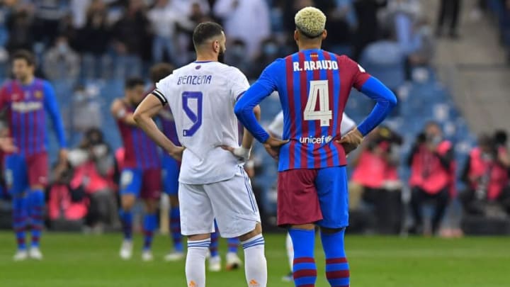 Karim Benzema (L) and Ronald Araujo look on during the Spanish Super Cup semi-final match between Barcelona and Real Madrid. (Photo by -/AFP via Getty Images)