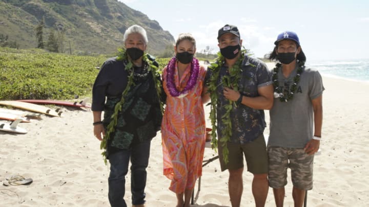 NCIS: HAWAIʹI kicked off its first season production at Mokulē‘ia Beach on Oahu with a traditional Hawaiian blessing in honor of its host Hawaiian culture, which was held in line with the series’ overall filming safety protocols. Series stars Vanessa Lachey, Noah Mills, Jason Antoon, Yasmine Al-Bustami and Tori Anderson, as well as the producers and the NCIS: HAWAIʹI crew, participated. Kahu (Officiant) Kordell Kekoa officiated the ceremony, which included traditional royal maile leis, Oli Aloha (welcoming chant), and Pule Ho’oku’u (closing prayer). In honor of the show’s premiere season, the ceremony centered on the constant motion of the ocean and how the moving ocean waters, driven by the winds and tides, connects the entire planet. Pictured L-R: Kahu (Officiant) Ramsey Taum presides over the blessing ceremony, Vanessa Lachey, Executive Producer / Director Larry Teng, and Director of Photography Yasu Tanida Photo: Karen Neal/CBS ©2021 CBS Broadcasting, Inc. All Rights Reserved.
