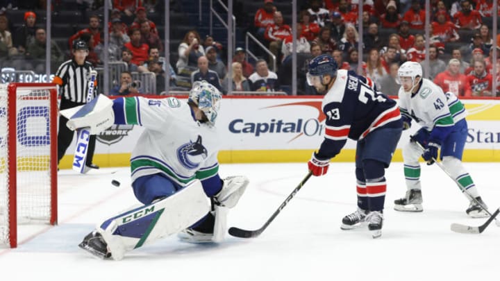 Oct 17, 2022; Washington, District of Columbia, USA; Washington Capitals left wing Conor Sheary (73) scores a goal on Vancouver Canucks goaltender Thatcher Demko (35) in the third period at Capital One Arena. Mandatory Credit: Geoff Burke-USA TODAY Sports