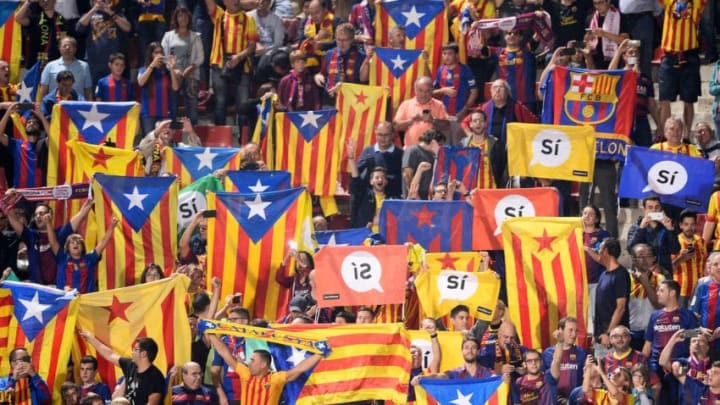 Catalan football fans hold Esteladas and flag reading 'Yes' before the Spanish league football match Girona FC vs FC Barcelona at the Montilivi stadium in Girona on September 23, 2017.Spain's Prime Minister Mariano Rajoy asked Catalan separatist leaders today to own up they can't hold an outlawed independence referendum after a crackdown dealt them a serious blow this week. / AFP PHOTO / Josep LAGO (Photo credit should read JOSEP LAGO/AFP/Getty Images)