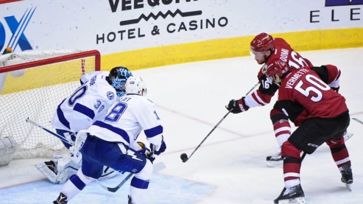 Mar 19, 2016; Glendale, AZ, USA; Arizona Coyotes center Max Domi (16) shoots the puck as center Antoine Vermette (50) looks on and Tampa Bay Lightning goalie Ben Bishop (30) and left wing Ondrej Palat (18) defend during the second period at Gila River Arena. Mandatory Credit: Matt Kartozian-USA TODAY Sports