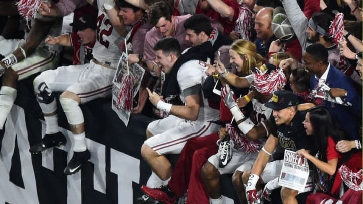 Jan 11, 2016; Glendale, AZ, USA; Alabama Crimson Tide players greet fans in the stands after the game against the Clemson Tigers in the 2016 CFP National Championship at University of Phoenix Stadium. Alabama won 45-40. Mandatory Credit: Gary A. Vasquez-USA TODAY Sports