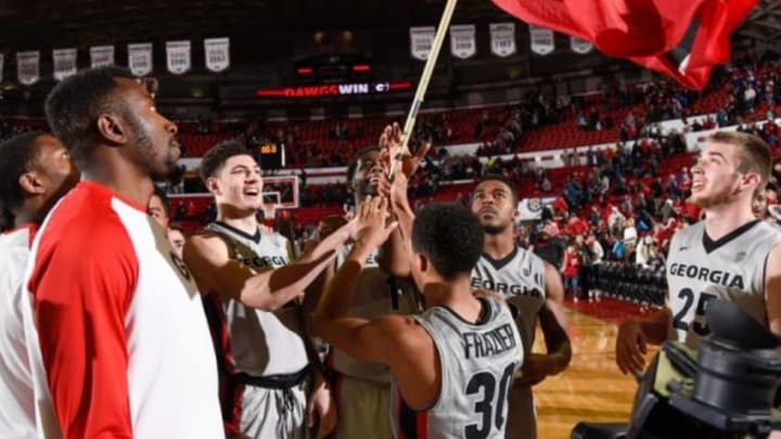 Jan 23, 2016; Athens, GA, USA; Georgia Bulldogs players celebrate their win against the Arkansas Razorbacks by waving their flag at Stegeman Coliseum. Georgia defeated Arkansas 76-73 in overtime. Mandatory Credit: Dale Zanine-USA TODAY Sports