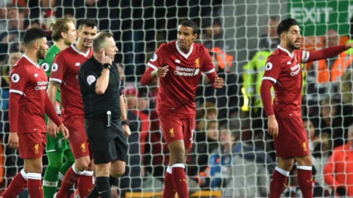 Joel Matip of Liverpool argues with referee Jonathan Moss. (Photo by Michael Regan/Getty Images)