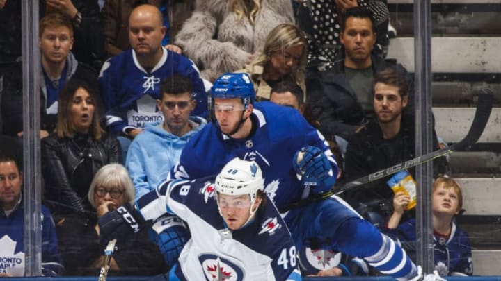 TORONTO, ON - OCTOBER 27: Brendan Lemieux #48 of the Winnipeg Jets checks Martin Marincin #52 of the Toronto Maple Leafs during the third period at the Scotiabank Arena on October 27, 2018 in Toronto, Ontario, Canada. (Photo by Mark Blinch/NHLI via Getty Images)