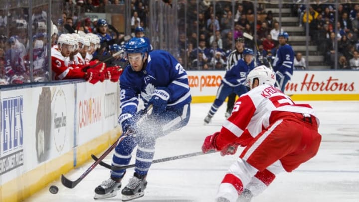 TORONTO, ON - DECEMBER 23: Connor Brown #28 of the Toronto Maple Leafs battles for the puck with Niklas Kronwall #55 of the Detroit Red Wings during the first period at the Scotiabank Arena on December 23, 2018 in Toronto, Ontario, Canada. (Photo by Mark Blinch/NHLI via Getty Images)