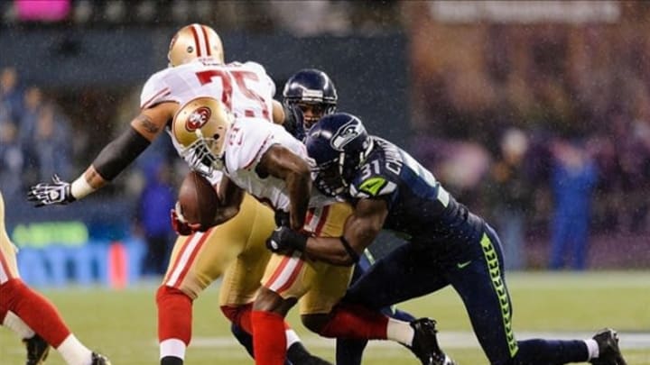 Dec 23, 2012; Seattle, WA, USA; Seattle Seahawks strong safety Kam Chancellor (31) forces San Francisco 49ers running back Frank Gore (21) to fumble the ball during the 1st half at CenturyLink Field. Seattle defeated San Francisco 42-13. Mandatory Credit: Steven Bisig-USA TODAY Sports