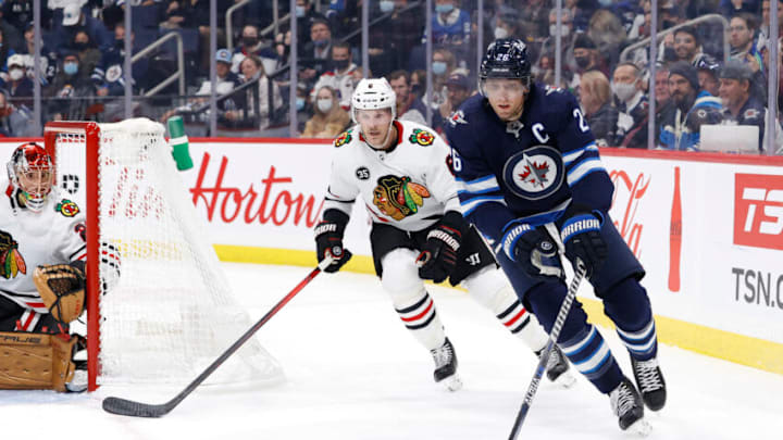 Nov 5, 2021; Winnipeg, Manitoba, CAN; Chicago Blackhawks defenseman Jake McCabe (6) chases down Winnipeg Jets right wing Blake Wheeler (26) in the second period at Canada Life Centre. Mandatory Credit: James Carey Lauder-USA TODAY Sports