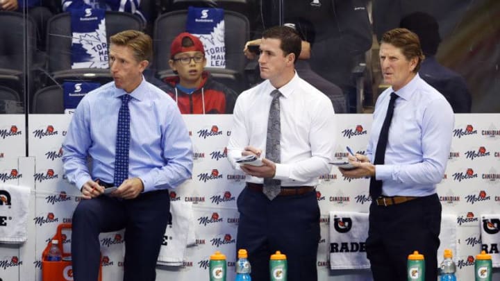 Assistant Coaches Dave Hakstol, Paul McFarland and Head Coach Mike Babcock of the Toronto Maple Leafs look on from the bench prior to an NHL game against the Ottawa Senators at Scotiabank Arena. (Photo by Vaughn Ridley/Getty Images)
