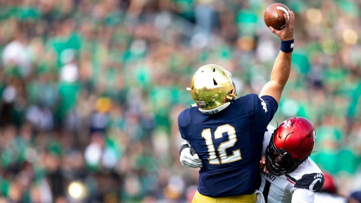 Cincinnati Bearcats defensive lineman Myjai Sanders (21) hits Notre Dame Fighting Irish defensive lineman Jordan Botelho (12) as he throws an interception made by Cincinnati Bearcats linebacker Deshawn Pace (20) in the first half of the NCAA football game between the Cincinnati Bearcats and the Notre Dame Fighting Irish on Saturday, Oct. 2, 2021, at Notre Dame Stadium in South Bend, Ind.Cincinnati Bearcats At Notre Dame Fighting Irish 185