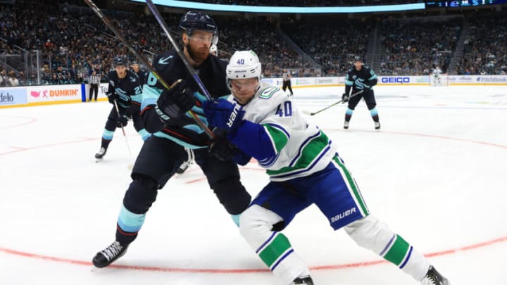 SEATTLE, WASHINGTON - OCTOBER 23: Elias Pettersson #40 of the Vancouver Canucks skates against Adam Larsson #6 of the Seattle Kraken in the third period during the Kraken's inaugural home opening game on October 23, 2021 at Climate Pledge Arena in Seattle, Washington. (Photo by Bruce Bennett/Getty Images)