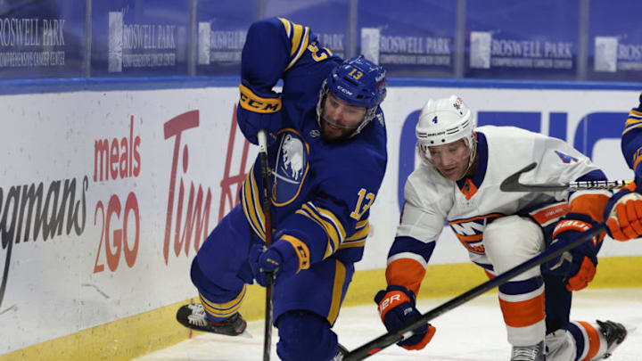 Feb 16, 2021; Buffalo, New York, USA; Buffalo Sabres center Tobias Rieder (13) goes after the puck as New York Islanders defenseman Andy Greene (4) defends during the second period at KeyBank Center. Mandatory Credit: Timothy T. Ludwig-USA TODAY Sports