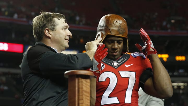 Sep 3, 2016; Atlanta, GA, USA; Georgia Bulldogs head coach Kirby Smart puts the Old Leather Helmet on running back Nick Chubb (27) after the 2016 Chick-Fil-A Kickoff game against the North Carolina Tar Heels at Georgia Dome. Georgia won 33-24. Mandatory Credit: Jason Getz-USA TODAY Sports