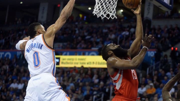 Jan 29, 2016; Oklahoma City, OK, USA; Oklahoma City Thunder guard Russell Westbrook (0) blocks a shot attempt by Houston Rockets guard James Harden (13) at Chesapeake Energy Arena. Mandatory Credit: Mark D. Smith-USA TODAY Sports