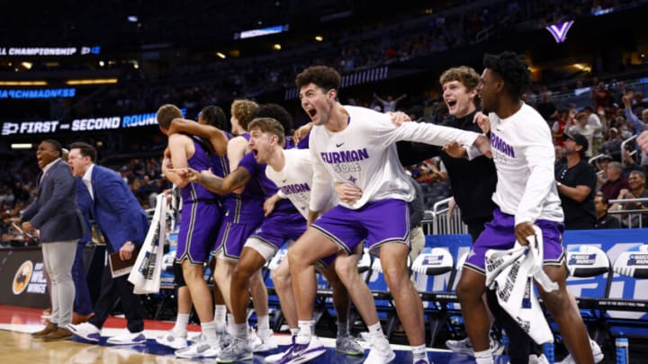ORLANDO, FLORIDA - MARCH 16: The Furman Paladins bench react against Virginia Cavaliers during the second half in the first round of the NCAA Men's Basketball Tournament at Amway Center on March 16, 2023 in Orlando, Florida. (Photo by Kevin Sabitus/Getty Images)