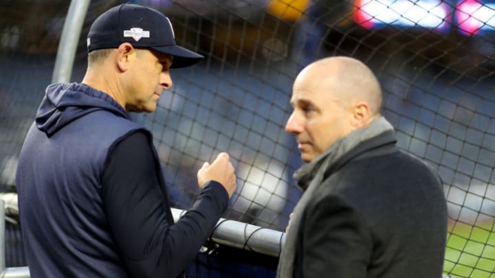 BRONX, NY - OCTOBER 17: Manager Aaron Boone #17 of the New York Yankees watches batting practice as General Manager Brian Cashman looks on prior to Game 4 of the ALCS between the Houston Astros and the New York Yankees at Yankee Stadium on Thursday, October 17, 2019 in the Bronx borough of New York City. (Photo by Alex Trautwig/MLB Photos via Getty Images)