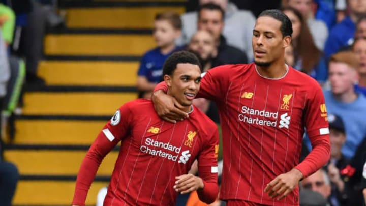 Liverpool’s English defender Trent Alexander-Arnold (L) celebrates with Liverpool’s Dutch defender Virgil van Dijk (R) after scoring the opening goal during the English Premier League football match between Chelsea and Liverpool at Stamford Bridge in London on September 22, 2019. (Photo by BEN STANSALL/AFP/Getty Images)