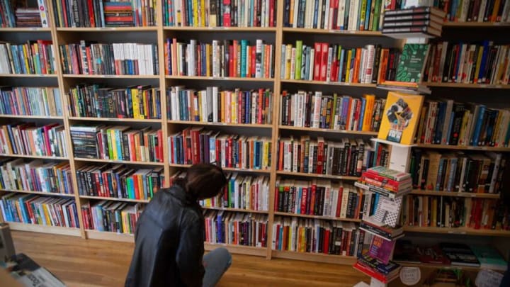 Cat Kuhn of Pittsburg looks over books on offer. The Asbury Book Cooperative is moving across Cookman Avenue to a new location. The move will allow the business to expand and offer more to its customers. Asbury Park, NJFriday, March 11, 2022.Asbury Book Cooperative 1d