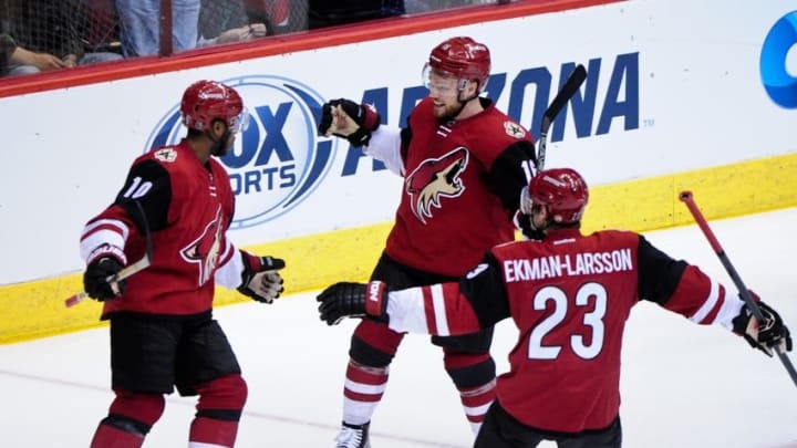 Feb 12, 2016; Glendale, AZ, USA; Arizona Coyotes left wing Anthony Duclair (10) celebrates with center Max Domi (16) and defenseman Oliver Ekman-Larsson (23) after scoring a goal in the second period against the Calgary Flames at Gila River Arena. Mandatory Credit: Matt Kartozian-USA TODAY Sports