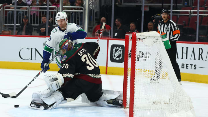 Apr 7, 2022; Glendale, Arizona, USA; Arizona Coyotes goaltender Harri Sateri (30) defends the goal against Vancouver Canucks right wing Alex Chiasson (39) during the third period at Gila River Arena. Mandatory Credit: Mark J. Rebilas-USA TODAY Sports