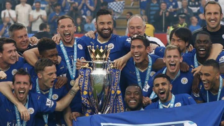 Leicester players celebrate with the Premier league trophy after winning the league and the English Premier League football match between Leicester City and Everton at King Power Stadium in Leicester, central England on May 7, 2016. / AFP / ADRIAN DENNIS / RESTRICTED TO EDITORIAL USE. No use with unauthorized audio, video, data, fixture lists, club/league logos or 'live' services. Online in-match use limited to 75 images, no video emulation. No use in betting, games or single club/league/player publications. / (Photo credit should read ADRIAN DENNIS/AFP/Getty Images)