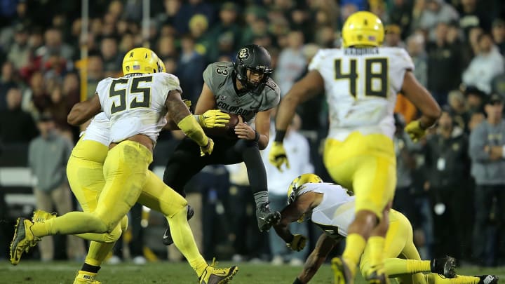 BOULDER, CO – OCTOBER 03: Quarterback Sefo Liufau #13 of the Colorado Buffaloes carries the ball against the Oregon Ducks defense at Folsom Field on October 3, 2015 in Boulder, Colorado. The Ducks defeated the Buffs 41-24. (Photo by Doug Pensinger/Getty Images)