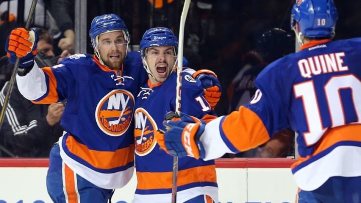 Apr 17, 2016; Brooklyn, NY, USA; New York Islanders center Shane Prince (11) celebrates his goal against the Florida Panthers with New York Islanders defenseman Calvin de Haan (44) and center Alan Quine (10) during the second period of game three of the first round of the 2016 Stanley Cup Playoffs at Barclays Center. Mandatory Credit: Brad Penner-USA TODAY Sports