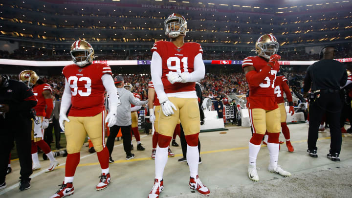SANTA CLARA, CA - NOVEMBER 24: D.J. Jones #93, Arik Armstead #91 and Dre Greenlaw #57 of the San Francisco 49ers stand on the sideline prior to the game against the Green Bay Packers at Levi's Stadium on November 24, 2019 in Santa Clara, California. The 49ers defeated the Packers 37-8. (Photo by Michael Zagaris/San Francisco 49ers/Getty Images)