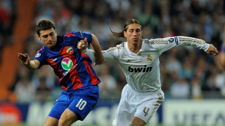MADRID, SPAIN - MARCH 14: Sergio Ramos (R) of Real Madrid battles for the ball against Alan Dzagoev of PFC CSKA Moskva during the UEFA Champions League Round of 16 second leg match between Real Madrid and PFC CSKA Moskva at estadio Santiago Bernabeu on March 14, 2012 in Madrid, Spain. (Photo by Denis Doyle/Getty Images)