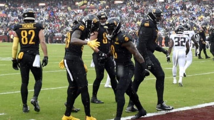 LANDOVER, MARYLAND – NOVEMBER 27: Brian Robinson Jr. #8 of the Washington Commanders celebrates a touchdown with teammates in the first quarter of a game against the Atlanta Falcons at FedExField on November 27, 2022 in Landover, Maryland. (Photo by Greg Fiume/Getty Images)