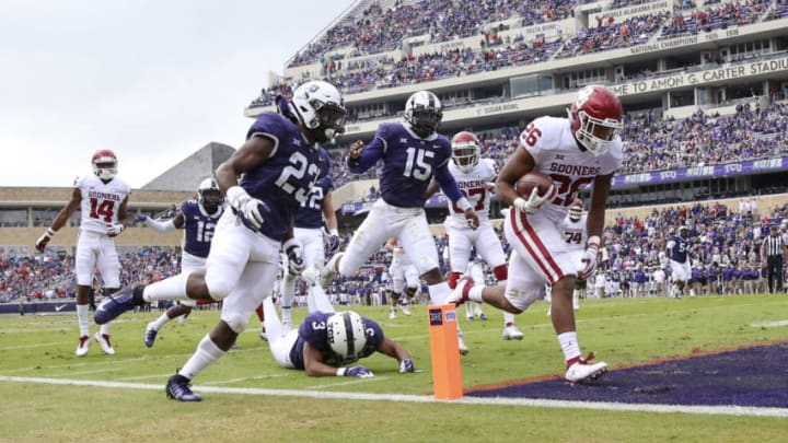 Oct 20, 2018; Fort Worth, TX, USA; Oklahoma Sooners running back Kennedy Brooks (26) runs for a touchdown past TCU Horned Frogs defensive end Ben Banogu (15) during the first half at Amon G. Carter Stadium. Mandatory Credit: Kevin Jairaj-USA TODAY Sports