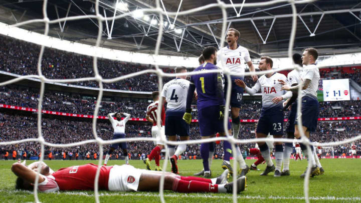 LONDON, ENGLAND - MARCH 02: Hugo Lloris of Tottenham Hotspur celebrates with teammates after saving a penalty whilst Pierre-Emerick Aubameyang of Arsenal looks dejected during the Premier League match between Tottenham Hotspur and Arsenal FC at Wembley Stadium on March 02, 2019 in London, United Kingdom. (Photo by Julian Finney/Getty Images)