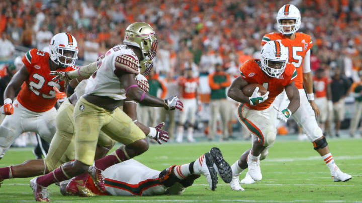 Miami running back Mark Walton, right, carries the ball against Florida State in the fourth quarter at Hard Rock Stadium in Miami Gardens, Fla., on Saturday, Oct. 8, 2016. Florida State won, 20-19. (David Santiago/El Nuevo Herald/TNS via Getty Images)